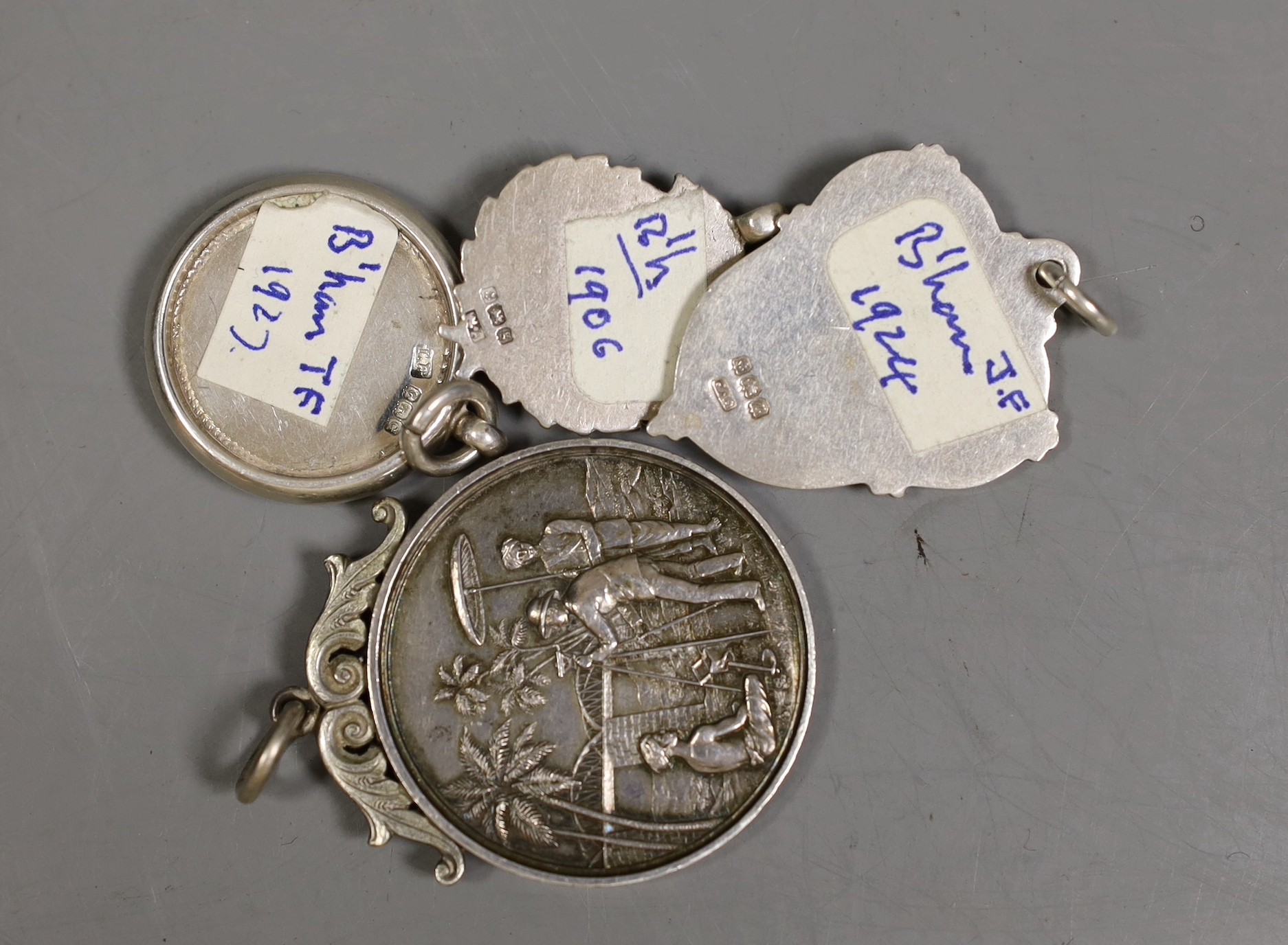 Fifteen assorted silver prize medallions, some with gold overlay, gross 113 grams, and a Madras College of Engineering medallion dated 1912